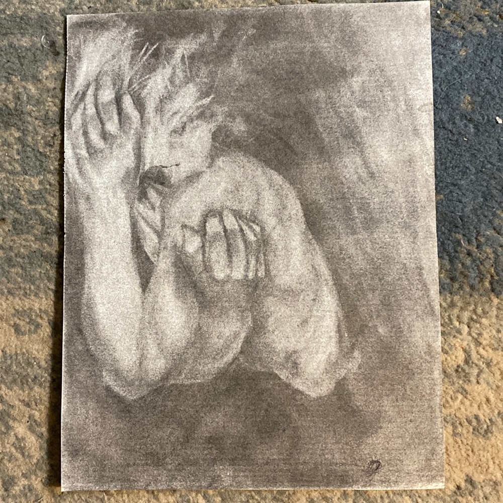 A person holding their face drawing I made. CHARCOAL DRAWING